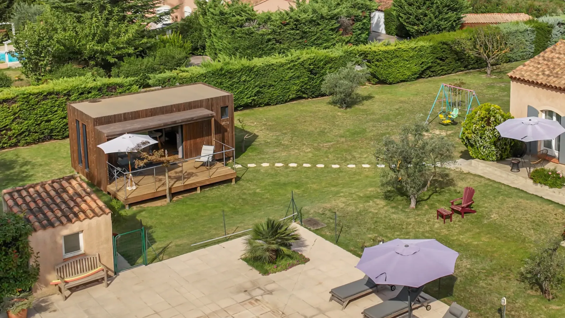 Vue aérienne d'une propriété avec un studio de jardin Greenkub GK20 en ossature bois au fond du jardin, à distance de la maison principale